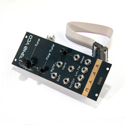 3340 VCO - analog oscillator module for eurorack synth. Gold plated PCB art, power cable and screws. shot from an angle.