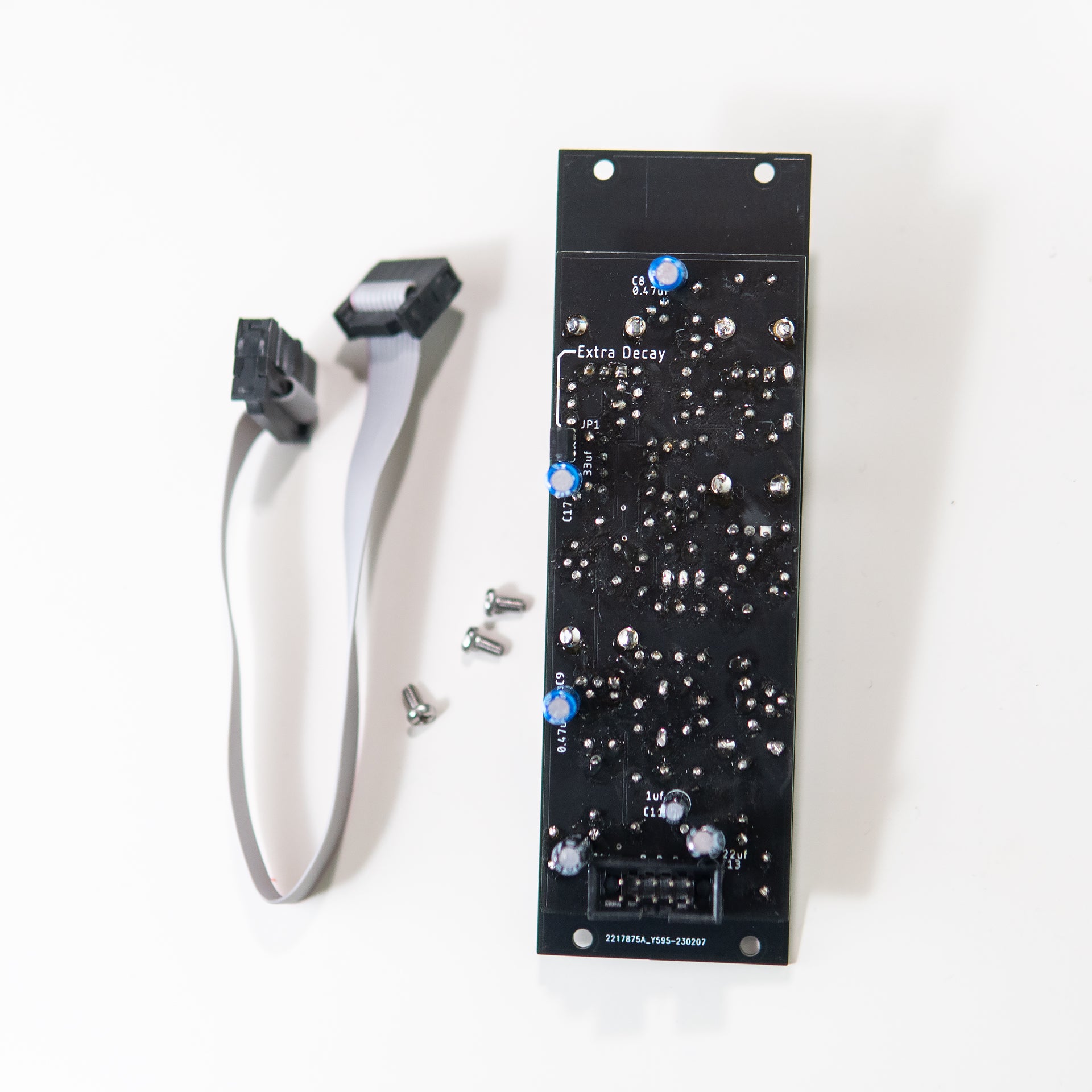A side-angle view of the 808 Bass Drum Eurorack module, highlighting the small jumper switch located on the bottom of the PCB. The jumper is labeled to indicate its function of bypassing the decay resistor.