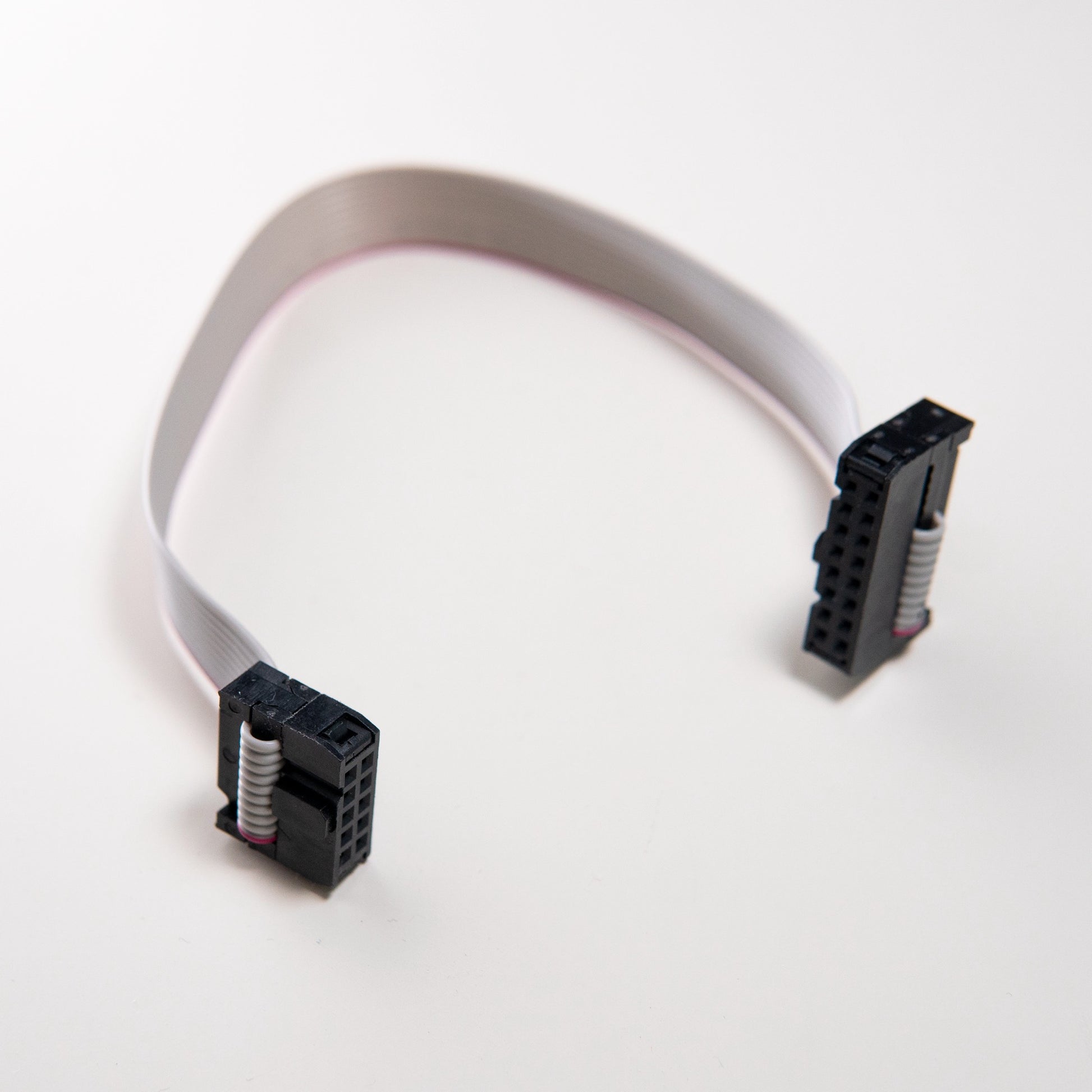 A 10-pin to 16-pin ribbon cable with IDC connectors for connecting Eurorack modules to a power bus board.