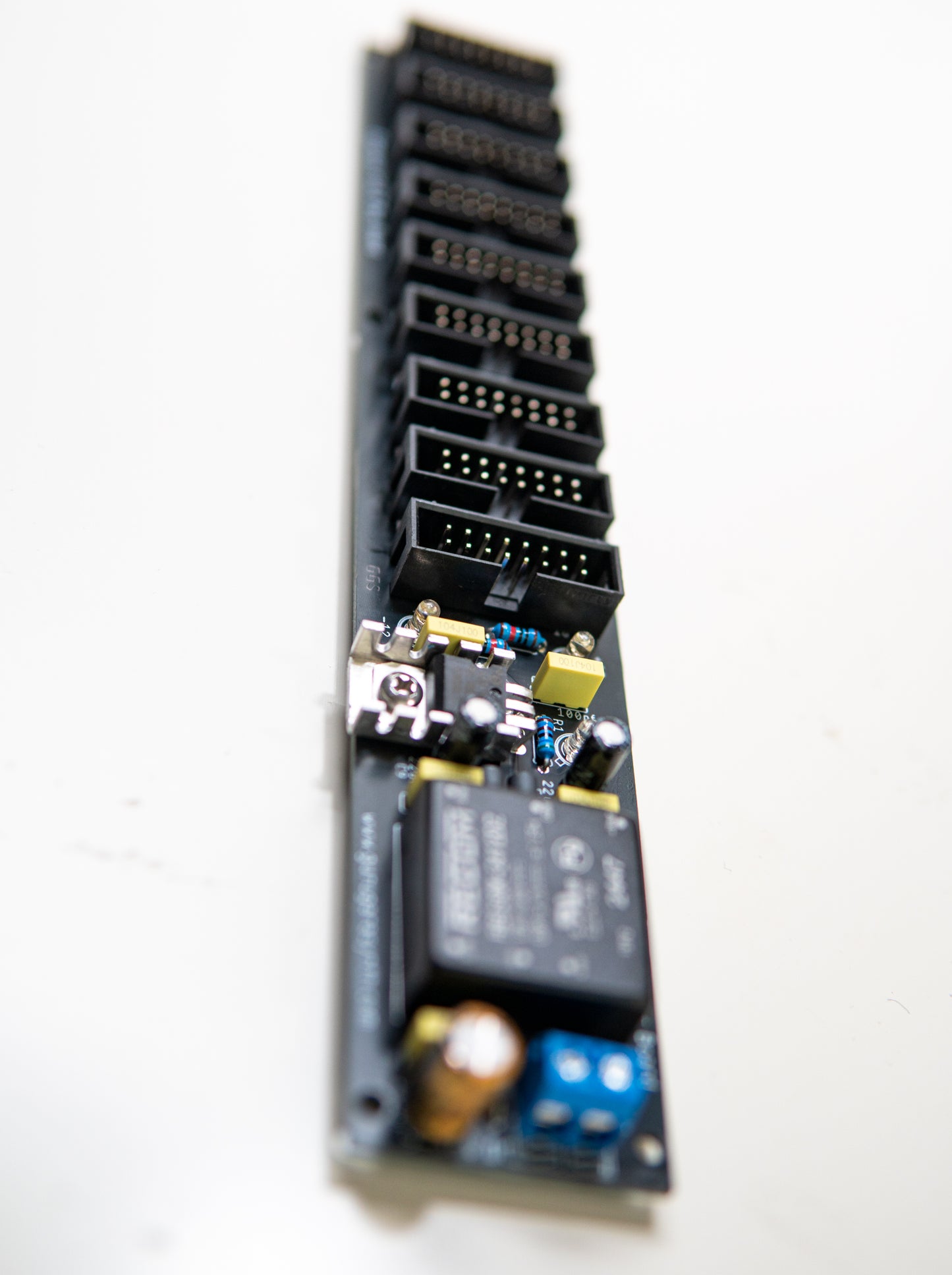 Eurorack power supply and bus board, power distribution. Synth PSU. +12V, -12V and +5V voltage regulator. 90 degree angle view.