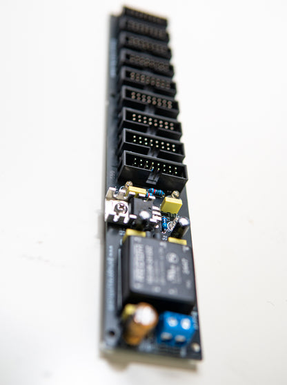 Eurorack power supply and bus board, power distribution. Synth PSU. +12V, -12V and +5V voltage regulator. 90 degree angle view.