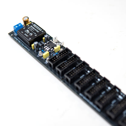 Eurorack power supply and bus board, power distribution. Synth PSU. +12V, -12V and +5V voltage regulator. Angled view. Electronic components visible.