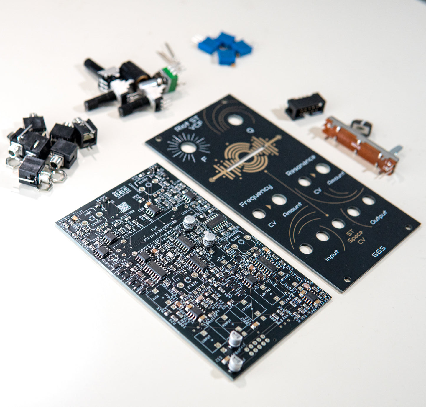 Riot ST VCF - Stereo Low Pass Filter for Eurorack modular synth. Full DIY kit. PCB, front panel and components visible. SMD and THT components such as jack sockets, potentiometers and filter. Photo with an ange.